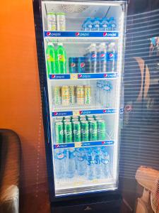 a refrigerator filled with lots of bottles of water at TT Hostel in Vientiane