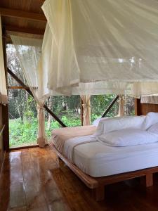 a bedroom with a bed with a canopy at Hacienda Herrera Tambopata in Puerto Maldonado