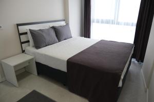 Postel nebo postele na pokoji v ubytování JK BUSINESS HOTEL