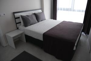 Postel nebo postele na pokoji v ubytování JK BUSINESS HOTEL