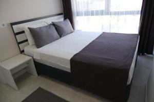 Postel nebo postele na pokoji v ubytování JK BUSINESS HOTEL