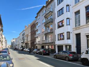 a street with cars parked on the side of the road at Trendy & sunny apartment in Ghent in Ghent