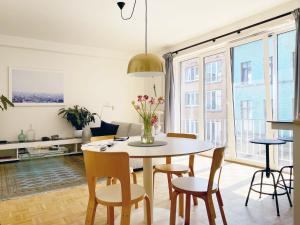a living room with a dining room table and chairs at Trendy & sunny apartment in Ghent in Ghent +31 photos