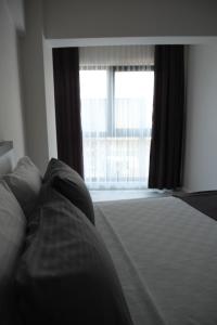 Postel nebo postele na pokoji v ubytování JK BUSINESS HOTEL