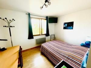 a bedroom with a bed and a window at Chambres à la Campagne in Moirans