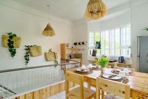 a kitchen with a wooden table and chairs in a room at Pallet Homes - Landheights Tropics in Iloilo City