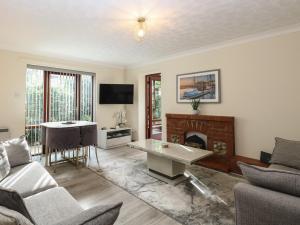 a living room with a couch and a fireplace at Seaview Cottage in Holt