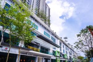 a white building with trees in front of a tall building at Southkey/Midvalley(A2301)Bathtub Netflix High Floor@JB in Johor Bahru