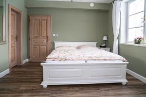 un letto bianco in una camera da letto con finestra di Apartmán Nad Modravou a Modrava