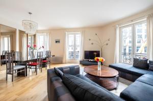 a living room with a couch and a table at Luxury style appartement, Arc de Triomphe - Champs Elysées in Paris