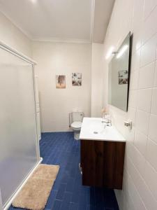 a bathroom with a white sink and a toilet at Casa Bienvenida in Bienvenida