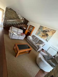 a living room with two couches and a coffee table at River House Viana in Viana do Castelo