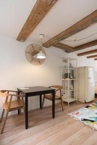 a dining room with a table and a refrigerator at Apartments Romance in Amsterdam