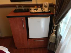 a small kitchen with a white refrigerator in a room at De Oude Herberg in Centurion