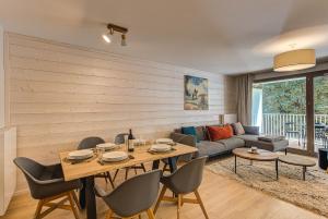 a living room with a table and chairs and a couch at White Pearl A13 - Alpes Travel - Central Chamonix (Sleeps 6) in Chamonix-Mont-Blanc