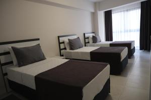 Postel nebo postele na pokoji v ubytování JK BUSINESS HOTEL