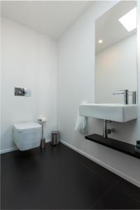 a white bathroom with a sink and a mirror at Orpheus - Isabel de Aragão - UNESCO Heritage in Coimbra +43 photos