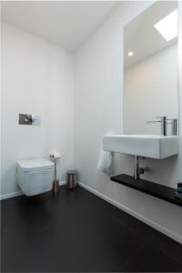 a white bathroom with a sink and a mirror at Orpheus - Isabel de Aragão - UNESCO Heritage in Coimbra