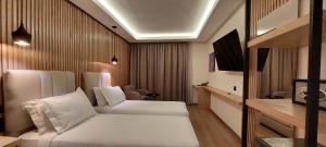 a hotel room with two beds and a chair at Unico Hotel & Spa Casablanca in Casablanca