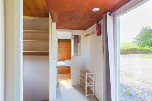 a room with a door leading to a bedroom at Mobilhome dans la prairie in Canihuel