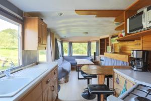 a kitchen and living room of an rv at Mobilhome dans la prairie in Canihuel