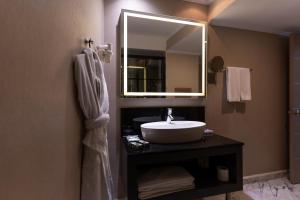 a bathroom with a sink and a mirror at Ankara Plaza Hotel in Ankara