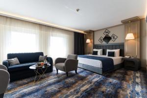 アンカラにあるアンカラ プラザ ホテルのベッドとソファ付きのホテルルーム