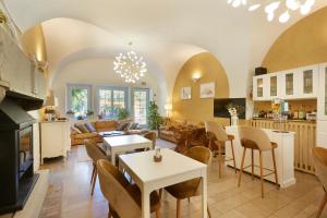 a living room with a table and chairs and a fireplace at Domaine de Bersaillin in Bersaillin