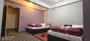 Postelja oz. postelje v sobi nastanitve Hotel TAMU ilam