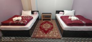 Postelja oz. postelje v sobi nastanitve Hotel TAMU ilam