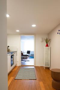 a kitchen and a living room with a table at City Apartment mitten in Dornbirn große Wohnung mit 4 Schlafmöglichkeiten - Ibiza 3 in Dornbirn