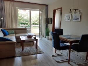 a living room with a couch and a table at Ferienwohnung Ranke in Scharbeutz_ in Haffkrug