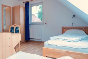 a bedroom with a bed and a dresser and a window at Am Deich 40 in Zingst