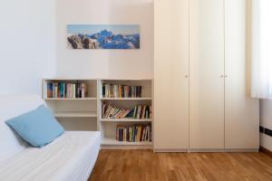 a bedroom with a bed and book shelves at Cavallotti Home in Bologna
