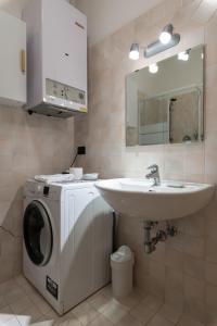 a bathroom with a washing machine and a sink at Cavallotti Home in Bologna