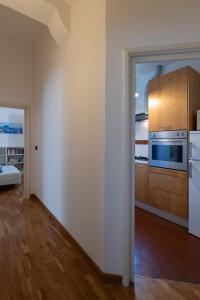 a kitchen with wooden cabinets and a white refrigerator at Cavallotti Home in Bologna