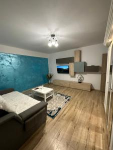 a living room with a couch and a table at Jasmine Apartment in Iaşi