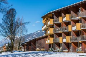 a building with snow in front of it at AEC Vacances - Les Becchi in Samoëns