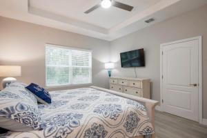 a bedroom with a bed and a flat screen tv at Amenity-Rich New Build; Dogs OK in Dunnellon