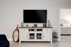 a white entertainment center with a flat screen tv on top at Amenity-Rich New Build; Dogs OK in Dunnellon