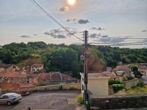 a car parked in a parking lot in a town at Maison ville haute Bar le Duc in Bar-le-Duc +1 photo