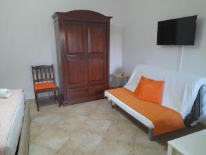 a living room with a couch and a tv at ARISTOCASA in Lecce