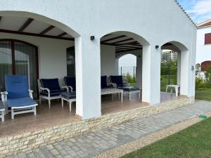 a patio with chairs and tables on a house at Vila Y2 in Arena Regia Residence - Adults only-14 and above- No parties allowed in Mamaia Nord
