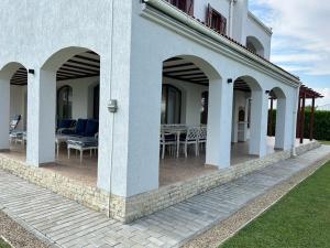 a patio with chairs and tables on a building at Vila Y2 in Arena Regia Residence - Adults only-14 and above- No parties allowed in Mamaia Nord