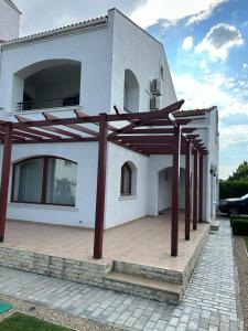 a large white house with a large patio at Vila Y2 in Arena Regia Residence - Adults only-14 and above- No parties allowed in Mamaia Nord +37 photos