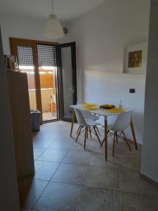 a kitchen with a table and chairs in a room at ARISTOCASA in Lecce