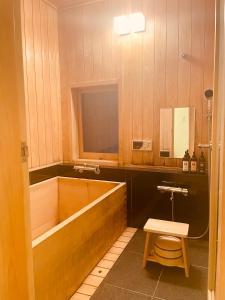 a bathroom with a tub and a toilet and a sink at 京都　水凪庵　Kyoto Mizunagian in Giommachi