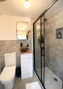 y baño con aseo, ducha y lavamanos. en Lumin Lodge -Calm, cosy space near Norwich Airport, en Horsham St Faith
