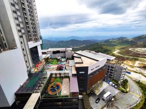 an aerial view of a city with mountains in the background at TopGenting SkySunColdSuite5Pax at GrdIonDelmn in Genting Highlands