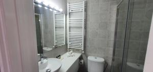 a bathroom with a sink and a toilet and a mirror at Bougainvillea House Lefkara in Pano Lefkara +22 photos